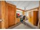 Functional office with wood paneling, built in desk, carpet flooring, and ample storage space at 1610 Reynolds Rd # 353, Lakeland, FL 33801