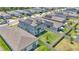 Aerial shot showcases a two-story home with solar panels and fenced backyard in a residential neighborhood at 1859 Carnostie Rd, Winter Haven, FL 33884