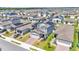 Aerial view of a neighborhood featuring multiple two-story homes with solar panels at 1859 Carnostie Rd, Winter Haven, FL 33884