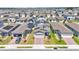 Aerial view of a neighborhood featuring multiple two-story homes with solar panels at 1859 Carnostie Rd, Winter Haven, FL 33884