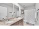 Bathroom features double sinks, granite countertops, shower, and decor at 1859 Carnostie Rd, Winter Haven, FL 33884
