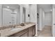 Bathroom showcasing a double vanity, tile flooring, and a shower with glass door at 1859 Carnostie Rd, Winter Haven, FL 33884