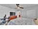 Bright bedroom featuring a ceiling fan, TV, and an ensuite bathroom access at 1859 Carnostie Rd, Winter Haven, FL 33884