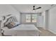 The bedroom has neutral walls, carpet, a white headboard and ceiling fan at 1859 Carnostie Rd, Winter Haven, FL 33884