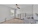 Bright bedroom with crib, dresser, ceiling fan, and lots of natural light at 1859 Carnostie Rd, Winter Haven, FL 33884