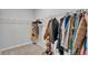 Walk-in closet showing hanging cloths and an organization system at 1859 Carnostie Rd, Winter Haven, FL 33884