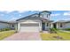 Charming two-story home with attached garage and brick driveway at 1859 Carnostie Rd, Winter Haven, FL 33884