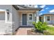 Charming front entrance with stone accents, a brick path and garden at 1859 Carnostie Rd, Winter Haven, FL 33884