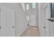 Bright hallway featuring neutral paint, tile floors, and a staircase leading to the upper level at 1859 Carnostie Rd, Winter Haven, FL 33884