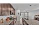 Open kitchen with granite countertops, stainless steel appliances and views of the dining area at 1859 Carnostie Rd, Winter Haven, FL 33884