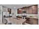 Spacious kitchen with granite countertops, stainless steel appliances, and dark wood cabinetry at 1859 Carnostie Rd, Winter Haven, FL 33884