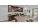 Modern kitchen with granite countertops, stainless steel appliances, and dark wood cabinets at 1859 Carnostie Rd, Winter Haven, FL 33884