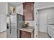 View of a stainless steel refrigerator and granite countertops in a modern kitchen at 1859 Carnostie Rd, Winter Haven, FL 33884