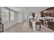 Open concept kitchen with stainless steel appliances, tile floors, an island with three stools, and light walls at 1859 Carnostie Rd, Winter Haven, FL 33884