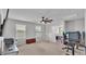 Bright upstairs carpeted living room with ceiling fan, windows, and ample space at 1859 Carnostie Rd, Winter Haven, FL 33884