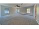 Expansive main bedroom with neutral carpeting, a ceiling fan, and ample natural light at 6918 Lake Eaglebrooke Dr, Lakeland, FL 33813
