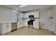 Modern kitchen featuring stainless steel appliances, white cabinets, and stone countertops at 6918 Lake Eaglebrooke Dr, Lakeland, FL 33813