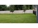 Large grassy backyard enclosed by a white fence at 753 Grand Hilltop Dr, Apopka, FL 32703