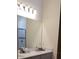 Bathroom featuring a large mirror, vanity, and glass-enclosed shower at 753 Grand Hilltop Dr, Apopka, FL 32703