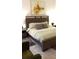 Comfortable bedroom featuring a wooden bed frame, bedside tables with lamps, and soothing decor at 753 Grand Hilltop Dr, Apopka, FL 32703