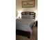 Comfortable bedroom with dark wood furniture and patterned bedding at 753 Grand Hilltop Dr, Apopka, FL 32703