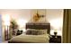 Comfortable bedroom featuring a wooden bed frame, bedside tables with lamps, and soothing decor at 753 Grand Hilltop Dr, Apopka, FL 32703