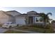 Charming home featuring a two-car garage, well-manicured lawn, and a modern exterior at 753 Grand Hilltop Dr, Apopka, FL 32703