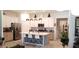 Bright kitchen with modern white cabinets, island with seating, and stainless steel appliances at 753 Grand Hilltop Dr, Apopka, FL 32703