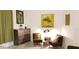 Stylish sitting area with a wooden dresser, two chairs, and complementary decor at 753 Grand Hilltop Dr, Apopka, FL 32703