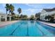Well-maintained swimming pool featuring lane dividers and surrounding landscaping for a serene atmosphere at 4767 Waltham Forest Dr, Davenport, FL 33837