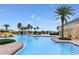 Resort-style pool area featuring a waterslide, palm trees, and poolside amenities for relaxation and recreation at 4767 Waltham Forest Dr, Davenport, FL 33837