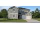 Charming two-story home with a two car garage, landscaped front yard, and neutral color palette at 1186 Osprey Roost Dr, Lakeland, FL 33801