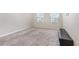 Neutral bedroom featuring plush carpeting, two windows for natural light, and a streamlined look at 1646 Seth Dr, Winter Haven, FL 33880