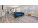 Open-concept living room with modern furniture, wood-look flooring, and an easy flow to the kitchen and dining area at 1646 Seth Dr, Winter Haven, FL 33880