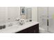 Modern bathroom showcasing double sinks, dark cabinets, and a glass-enclosed shower at 1845 Clear Sky Dr, Kissimmee, FL 34744