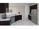 Bright kitchen featuring stainless steel appliances, dark cabinetry, and a spacious countertop at 1845 Clear Sky Dr, Kissimmee, FL 34744