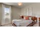 Cozy bedroom with a comfortable bed, neutral tones, and natural light from the window at 1863 Clear Sky Dr, Kissimmee, FL 34744