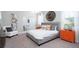 A stylish bedroom features a large bed, bright accent furniture, modern lighting, and neutral carpet at 1863 Clear Sky Dr, Kissimmee, FL 34744