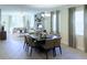 Open concept living and dining room features lots of windows, wood floors, modern lighting, and neutral decor at 1863 Clear Sky Dr, Kissimmee, FL 34744