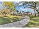Serene community walking path surrounded by mature trees and lush landscaping at 1863 Clear Sky Dr, Kissimmee, FL 34744
