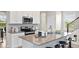 Modern kitchen featuring stainless steel appliances, gray countertops, and a convenient breakfast bar at 1880 Bright Sky Dr, Kissimmee, FL 34744