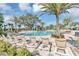 Resort-style community pool with lounge chairs and palm trees creating a relaxing atmosphere at 1911 Clear Sky Dr, Kissimmee, FL 34744