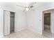 This bedroom has tile floors, ceiling fan, neutral walls, and access to an en suite bathroom and a closet at 222 Aldo Dr, Babson Park, FL 33827