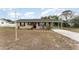 Charming single-story home with neutral paint, black shutters, and a covered carport at 222 Aldo Dr, Babson Park, FL 33827