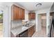 Modern kitchen featuring stainless steel appliances, granite countertops, and wood cabinets at 222 Aldo Dr, Babson Park, FL 33827