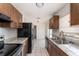 Bright kitchen with modern stainless appliances, granite countertops, and tiled floor at 222 Aldo Dr, Babson Park, FL 33827