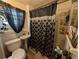 Bathroom featuring a toilet, sink, shower with decorative curtain, and window at 730 Citrus St, Orlando, FL 32805