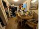 Dining room with wood table and chairs, next to the kitchen with black refrigerator at 730 Citrus St, Orlando, FL 32805