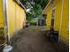Side view of the house and shed, showing a narrow passageway and various outdoor items at 730 Citrus St, Orlando, FL 32805