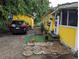 Side exterior view of house with shed, with brick pavers, green turf, and round stepping stones at 730 Citrus St, Orlando, FL 32805